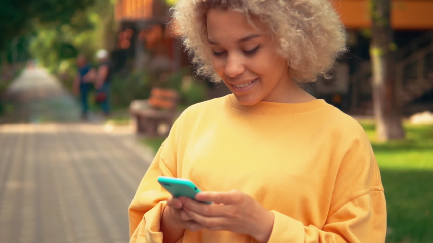 close up portrait beautiful mixed race woman chatting online happy smiling slow motion
