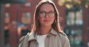Young Attractive Woman posing on Camera while standing on the central Square. Having stylish Eyeglasses and Earrings. Looking gorgeous and having nice Appearance. Girls. Portrait. Trendy Glasses.