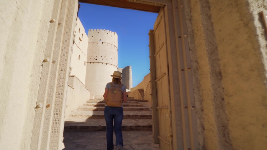 Young Foreign Female Tourist Visiting Ancient Bahla Fort in Oman