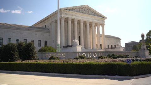 Motion to right of Supreme Court building in Washington DC on a sunny day.