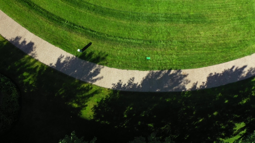 Moscow, Russia. Drone flying over beautiful green grass at summer day. Close up view of the green field in the park