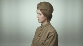 Video of woman wearing red army uniform on white