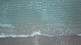 Aerial birds eye view looking down at sea waves crashing down. Green and blue sea top view drone, drone footage , 4k 
