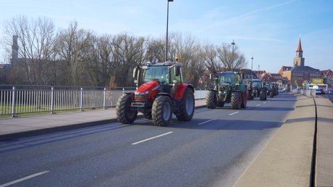 FUERTH/NUREMBERG, BAVARIA, GERMANY - 17. JANUARY 2020: Arrival of long convoy of 500 farm tractors in Fürth on their way to the farmer strike in Nürnberg. #bauernprotest shot from centre strip