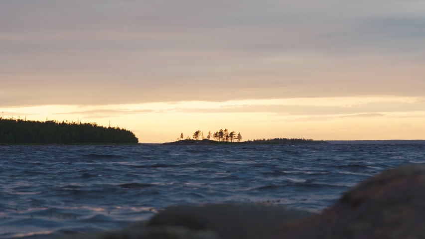 KARELIA,RUSSIA - SUMMER 2019: orange sunset on the White sea shore