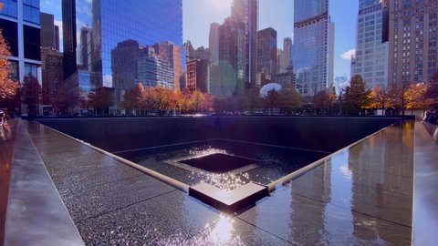 New York, NY, USA - 11-10-2019
the 9/11 memorial with a lot of reflection on a sunny day of autumn.