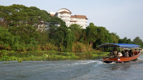 CHIANG MAI, THAILAND - May 11, 2019: Passing by a tourist boat on a river near Chiang Mai.