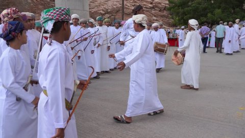 OMAN MUSCAT/ NOVEMBER 11, 2019:  Omani folk band performing Omani traditional dance. young boys dancing with drums
