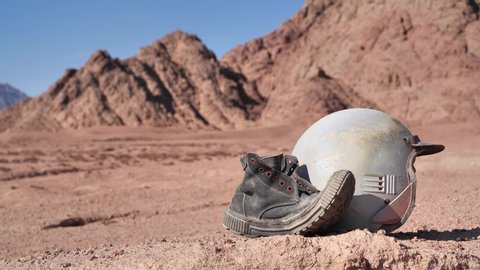 Old boot and motorcycle helmet in the desert, Sinai, Egypt