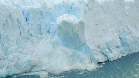 Global Climate change footage: nature is declining, and glaciers are melting. Climate awareness and warming video. The Perito Moreno glacier in Los Glaciares National Park collapses into a large lake.