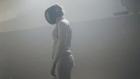 A female fencer holding a epee preparing to duel in a foggy fencing gym on a strip - Powered by Shutterstock - Get 15% off with code: PIKWIZARD15