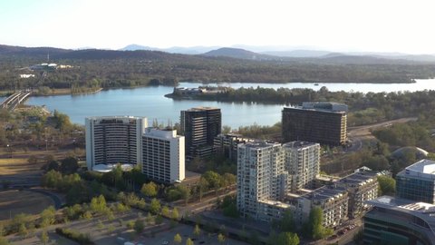 CANBERRA, AUSTRALIA – JANUARY 26, 2020: Aerial view of Canberra City, the capital of Australia, traveling south toward Lake Burley Griffin and Acton Peninsula on a sunny afternoon  
