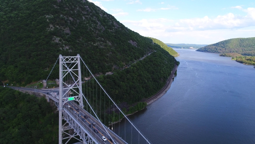 This is an aerial view of Bear Mountain Bridge. The Bear Mountain Bridge, ceremonially named the Purple Heart Veterans Memorial Bridge, is a toll suspension bridge in New York State.