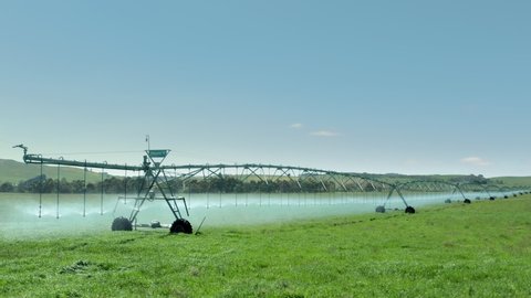 Melbourne, Victoria / Australia - November 13, 2019: camera panning across a center pivot irrigation machine on a farm - 4k drone video