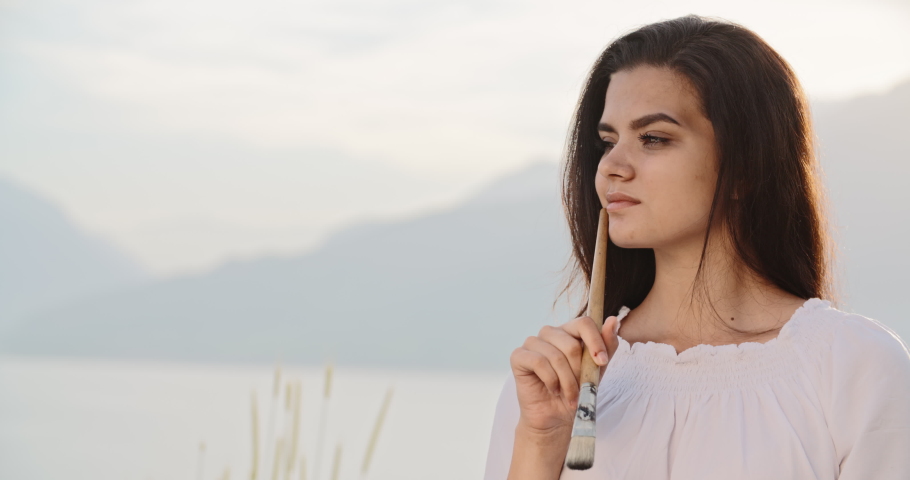Multiethnic female artist relaxing in mountains, making a picture inspired by beautiul view - recreational pursuit, hobby, inspirational landscape concept 4k footage