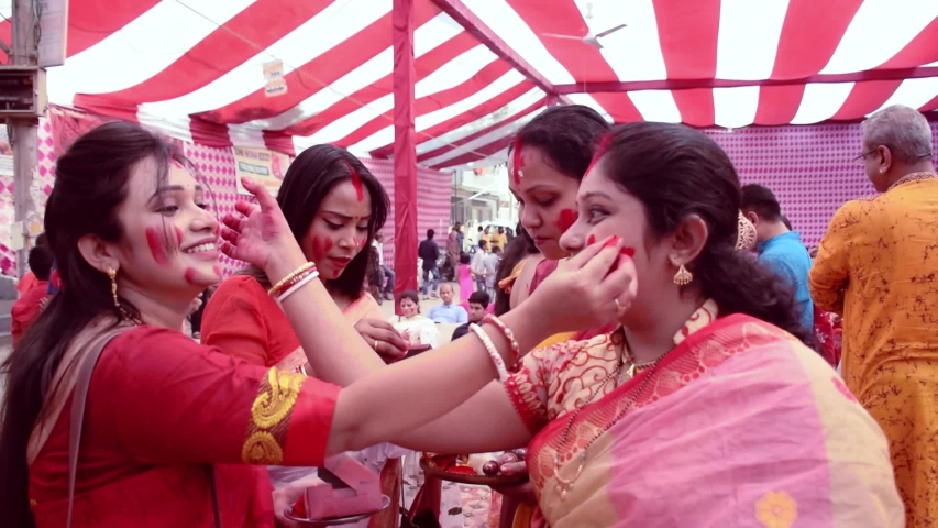 Durga Puja traditional Sindur Khela celebration -  Indian Bengali women playing with Vermilion also known as Sindoor Khela during auspicious Durga Pooja Festival 
Delhi -India
10th Oct 2019