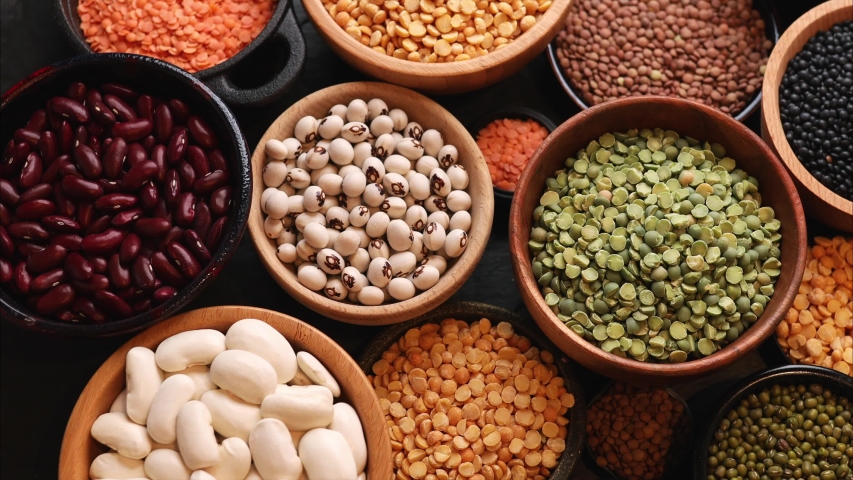Legumes, a set consisting of different types of beans, lentils and peas on a black background, top view, close up, 4k. The concept of healthy and nutritious food Royalty-Free Stock Footage #1046148442
