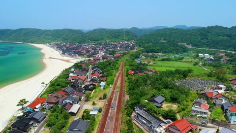 Aerial video by drone, shooting while moving from city area to Kotogahama