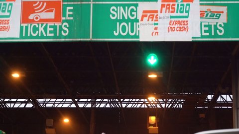 Delhi, India - circa 2019 : Panning up shot of the green boards of an NHAI toll booth covered with stickers for Fastag no cash post the mandatory implementation. The RFID readers and the automated