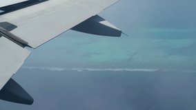 Top view of Maldives (Maldive) islands, with white sandy and turquoise colored  sea  from airplane window. 4K Video