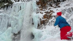 Adventure Photographer Taking Pictures of Frozen Waterfall Ice Cliffs on Snowshoe Hike - Powered by Shutterstock - Get 15% off with code: PIKWIZARD15
