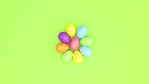 Chicken eggs dancing on green background - Looping stop motion 