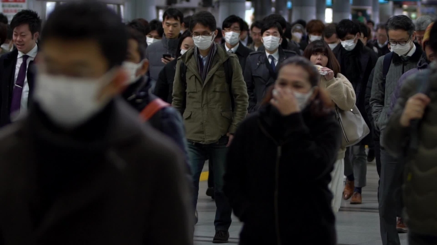 Tokyo, Japan-04 February, 2020: Slow motion of Japanese business men and women wear face masks. People wearing mask at metro as precautionary measures during coronavirus from Wuhan, China