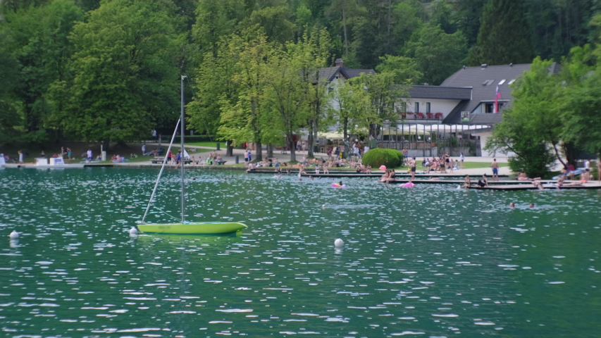 touristic recreation area on shore of Lake Bled in Slovenia, view from water