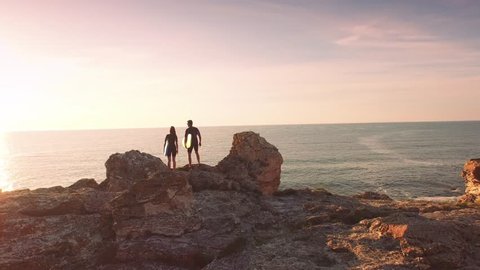 Young Surfers Man Woman Walking Standing On Top Of Cliff High Five Congratulations Achievement Sports Holiday Vacation Happiness Concept