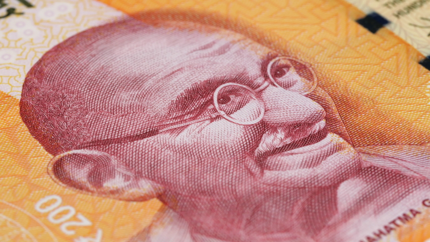 Mahatma Gandhi portrait on India 200 rupee banknote rotating. Low angle, macro. 4K, 422 10 bit