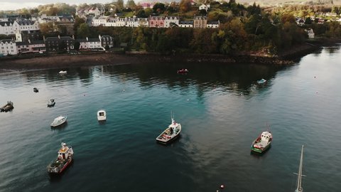 Portree , Scotland / United Kingdom (UK) - 11 10 2019: Isle of Skye Island Scotland UK, City Harbour Marina and Residental Buildings on Coast, Orbit Aerial