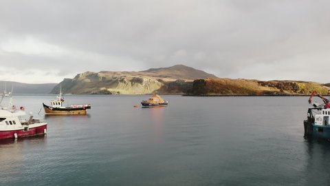 Portree , Scotland / United Kingdom (UK) - 11 10 2019: Aerial Approaching to Isle of Skye Island Coast Flying Beetween Local Fishing Boats