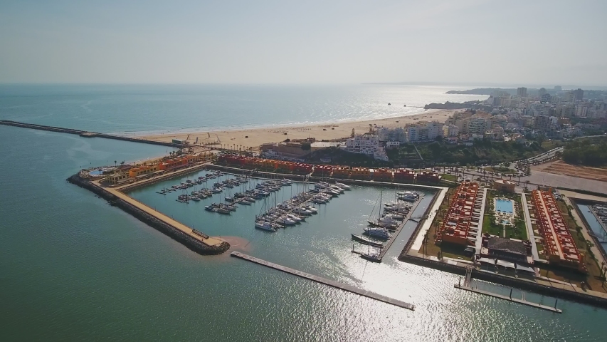 Aerial. Aerial view of a Portuguese marina with yachts and motor boats, the city of Portimao.