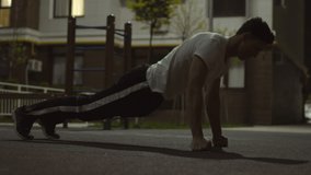 Muscular Caucasian man performing push ups exercise in urban city at night Athlete enjoying workout  - Powered by Shutterstock - Get 15% off with code: PIKWIZARD15