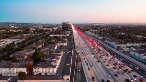 Aerial view of freeway and interstate traffic on I-405 in urban Los Angeles with cars below during twilight in the evening.