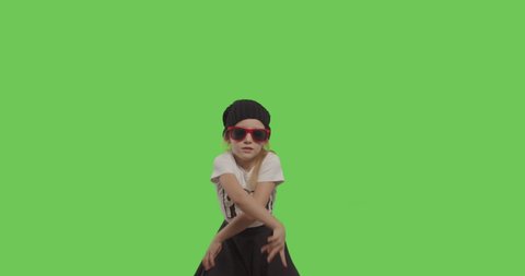 young beautiful girl dancing hip hop, dancehall, street dance over green screen background. Happy smiling child having fun on Chroma Key. 4k video footage slow motion 60 fps