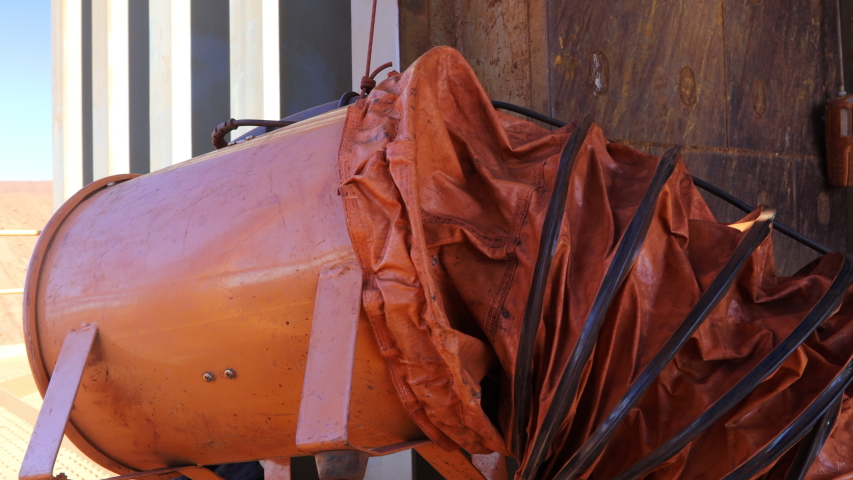Footage of safety precautions worker using ventilation fan while working inside the confined space, gas test leak detector hanging on entry, exit manhole door continue monitoring during hot work   