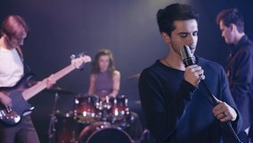 selective focus of singer performing with music band