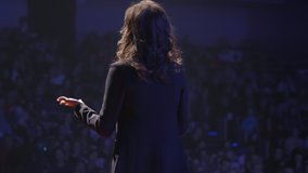 Elegant and Confident Motivated Business Woman Public Speaking at Finance Conference on Auditorium. Coach Emotional Gesturing Talks from Stage Spectators at Forum. CEO Female in Suit Standing Closeup - Powered by Shutterstock - Get 15% off with code: PIKWIZARD15
