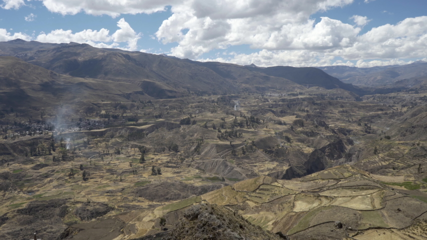 Panoramic view of the scenic landscape in the Colca Canyon (Cañón Del Colca) with stepped agricultural Inca terraces from a viewpoint. Travel destination around Arequipa in the Andes Mountains of Peru