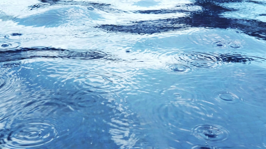 Blue water surface texture during rain. Monochrome classic blue background with place for text | Shutterstock HD Video #1046260234