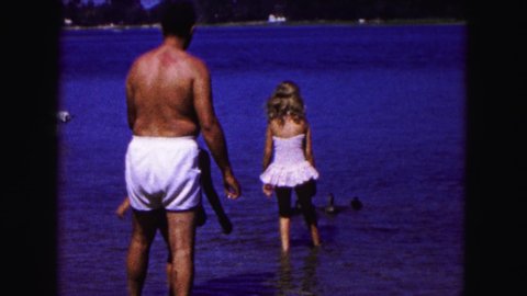 BUFFALO NEW YORK USA-1961: Father Daughter Summer Vacation Ducks Lake Family Swimming Beach Water