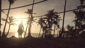 Sunrise on tropical beach, friends playing beach volleyball