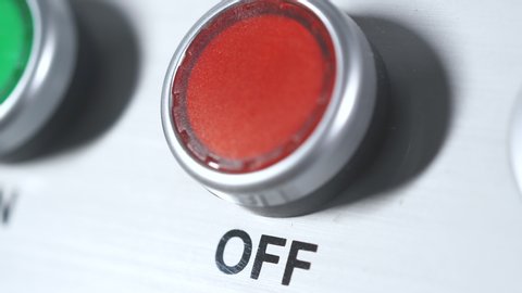 Red button power off. Finger pushing button. Shutdown engine electrical equipment in industrial factory. Panel with red plastic round pressbutton. End of work. Switch off. Turn off the electricity.