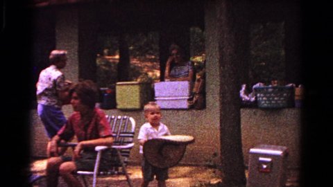 COLD SPRINGS NEW YORK USA-1963: Little Boy Walking With Sombrero And Mom Comes And Puts It On His Head