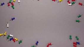 Stop motion animation of colorful push pins on gray background. Business office stress problems and social pressure or peer pressure concept. Education concept. Flat lay