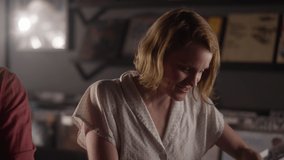 A young woman shows her friend the vinyl record she found in a record store - Powered by Shutterstock - Get 15% off with code: PIKWIZARD15