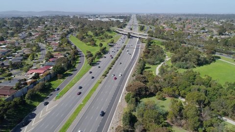 Forward flight over cars driving on Monash Freeway towards interchange in Melbourne, Australia