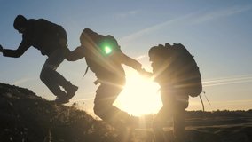 teamwork help business three men hold hand travel silhouette concept. group of tourists lends a helping hand climb the cliffs mountains. people climbers climb to the top overcoming lifestyle teamwork - Powered by Shutterstock - Get 15% off with code: PIKWIZARD15