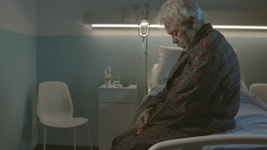 Sleepless senior man sitting on a hospital bed and rocking back and forth, dementia and disease symptoms Royalty-Free Stock Footage #1046306026